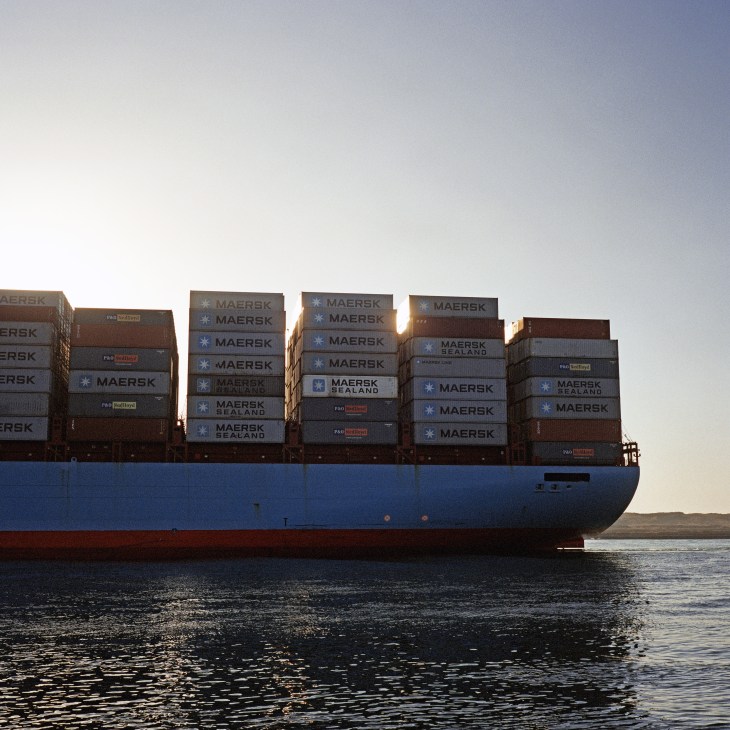 Container ship loaded with Maersk shipping containers passing through the Suez Canal.