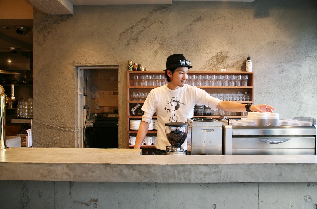 Staff member behind counter at Number A diner in Tokyo with blender and coffee equipment.