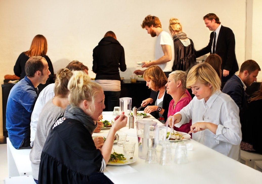 Staff members dining and socializing in the e-Types office canteen.