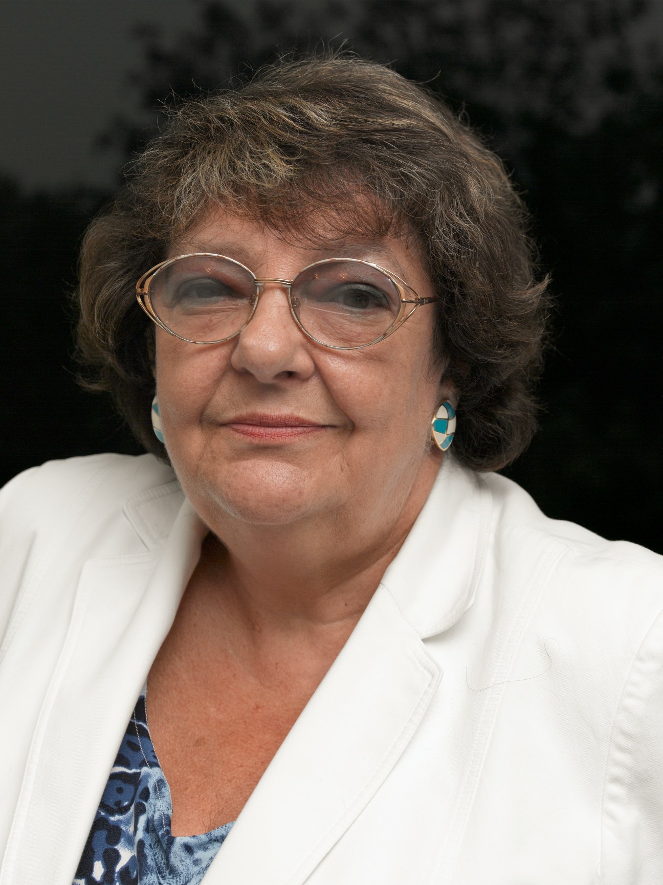Portrait of Irena Lesnevskaya, editor-in-chief of The New Times, wearing glasses and a white blazer.