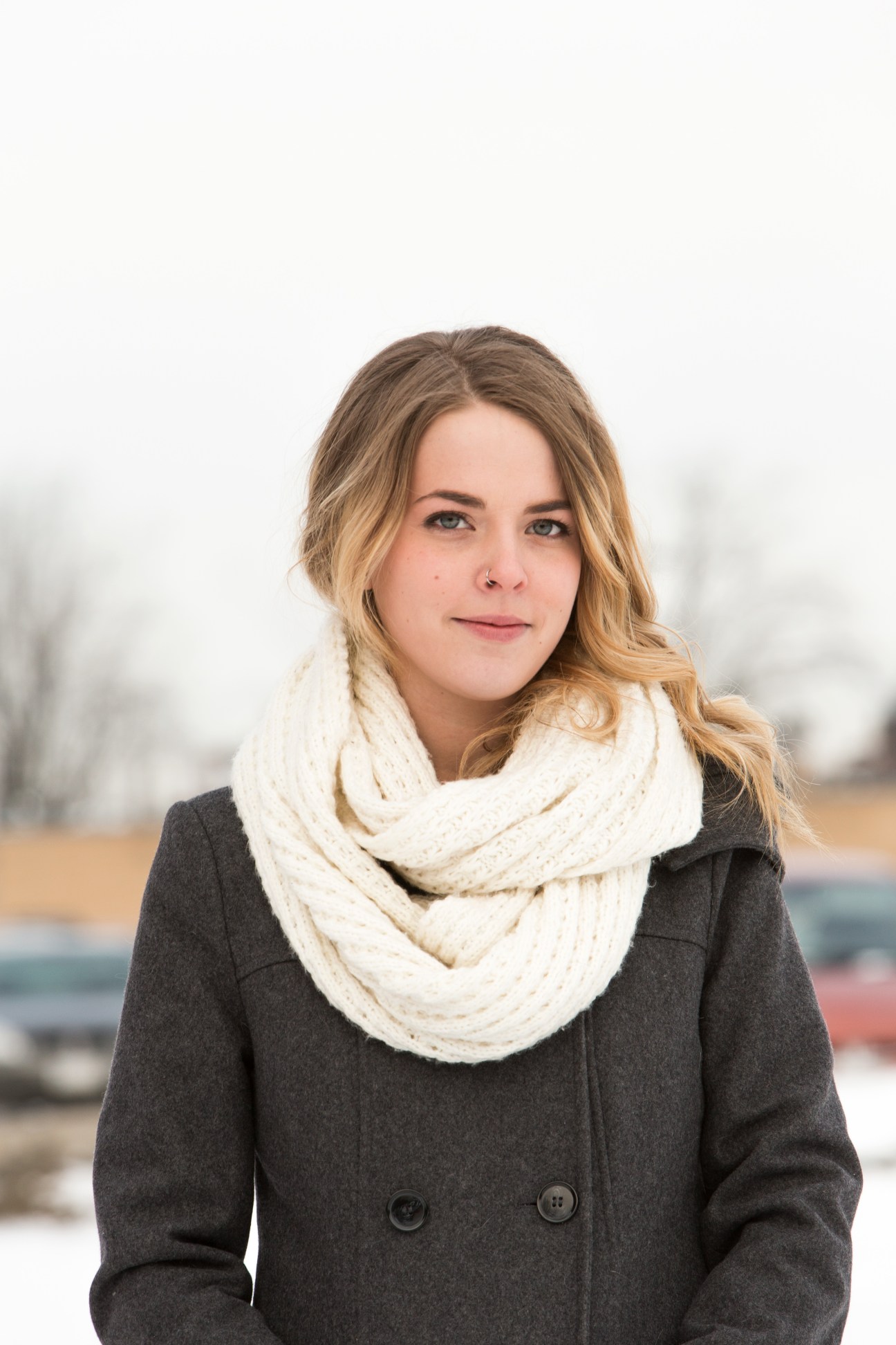 Local resident Kirsti Hayes poses for a portrait wearing a cream scarf and charcoal coat.