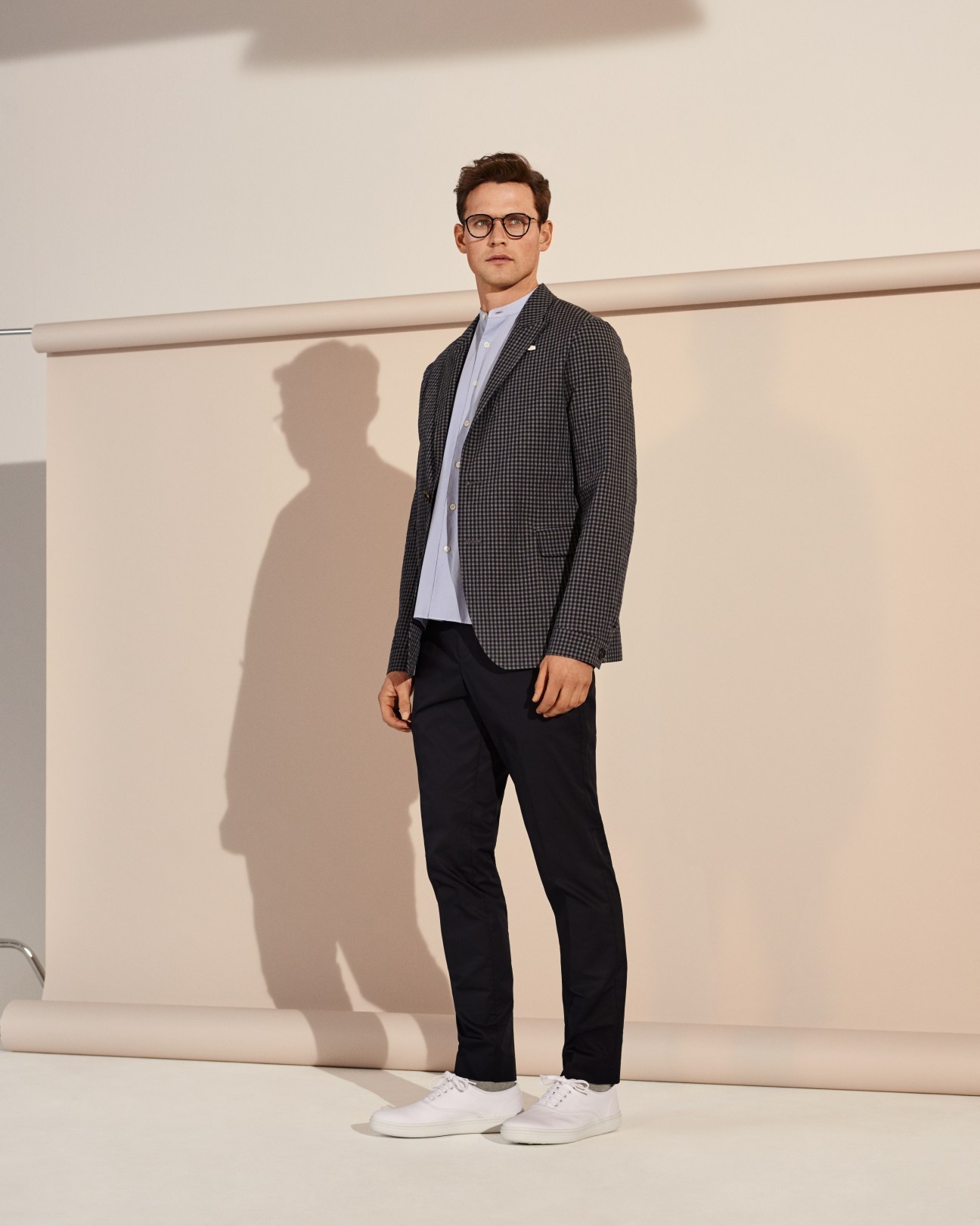 Man wearing Oliver Spencer jacket, Phlannel shirt, Tomorrowland trousers, Church's trainers and Eyevan 7285 glasses.