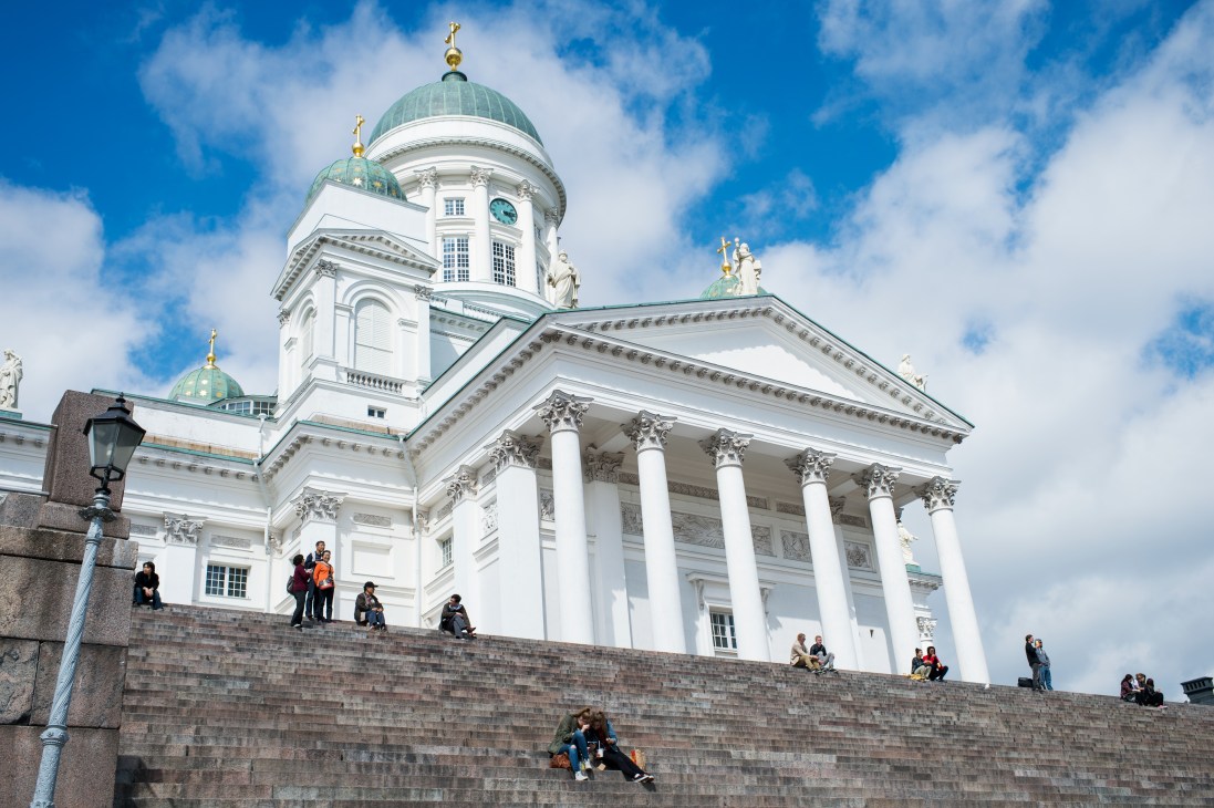 White neoclassical cathedral with green dome and gold cross, Helsinki