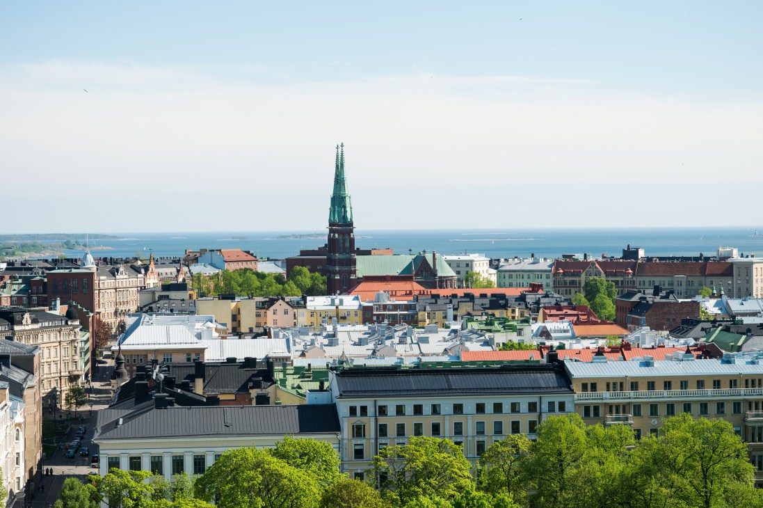 Aerial view of Helsinki cityscape with church spire and waterfront in background
