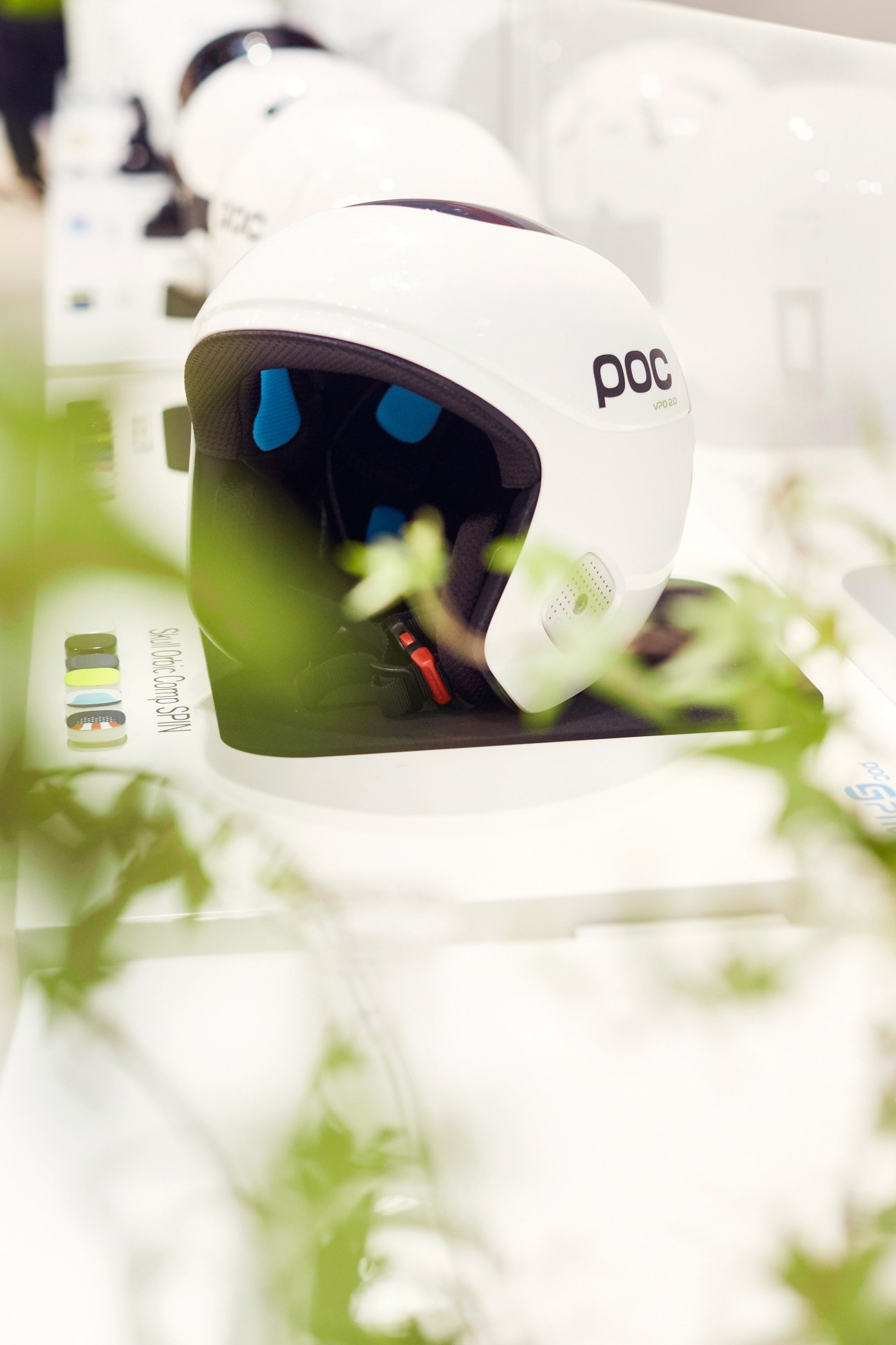 White POC Spin helmet with blue interior padding displayed at Ispo sportswear fair.