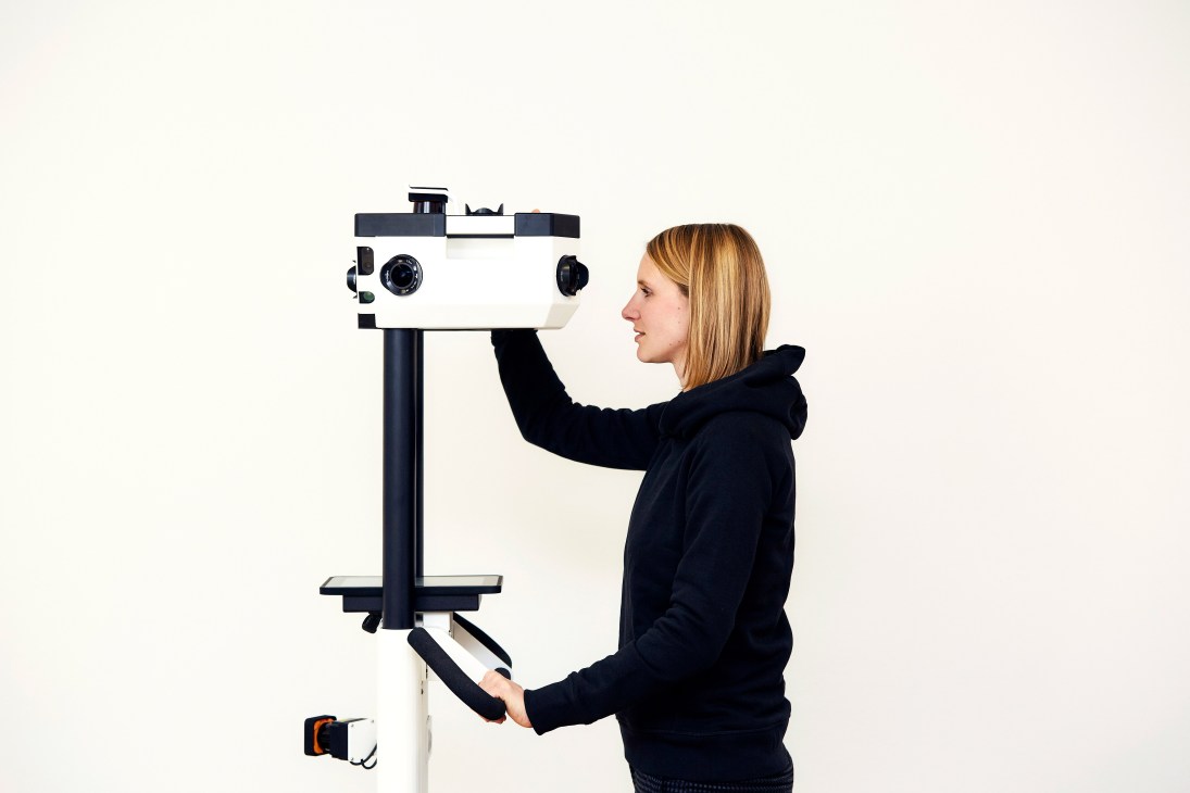 Woman operating NavVis M3 Mapping Trolley with cameras and sensors for indoor space mapping
