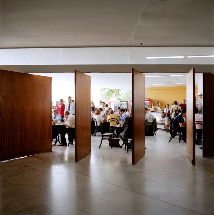 Ministry canteen with wooden partitions separating dining areas where staff gather during lunch break.