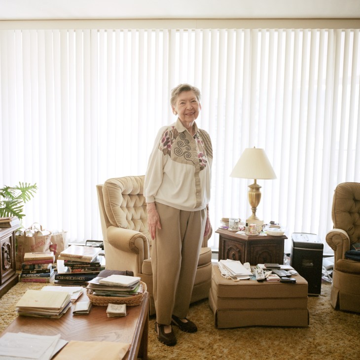 90-year-old Blanche Foster stands in her Marina City two-bedroom apartment surrounded by furniture and personal items.