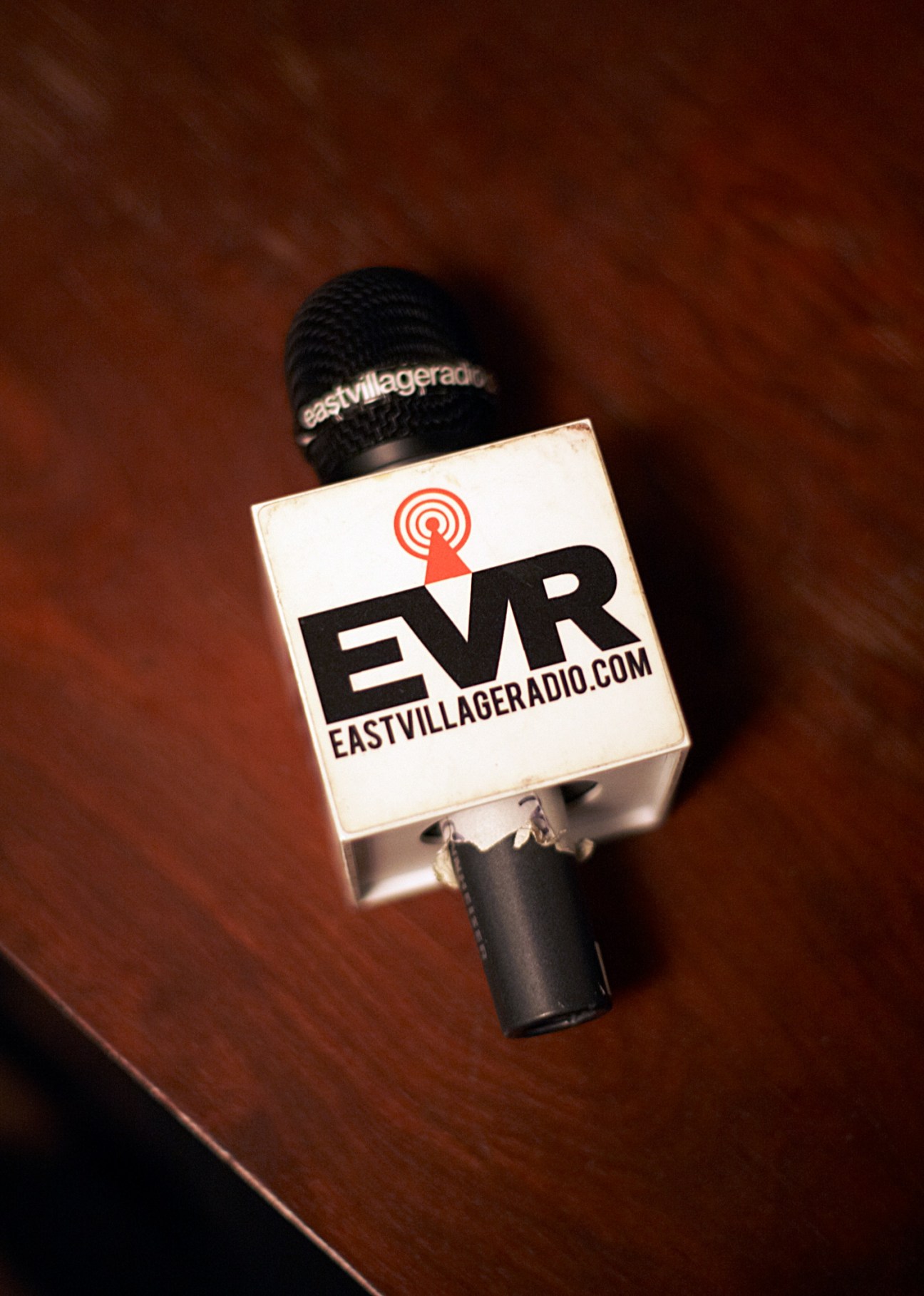 East Village Radio microphone with EVR logo against brown background.