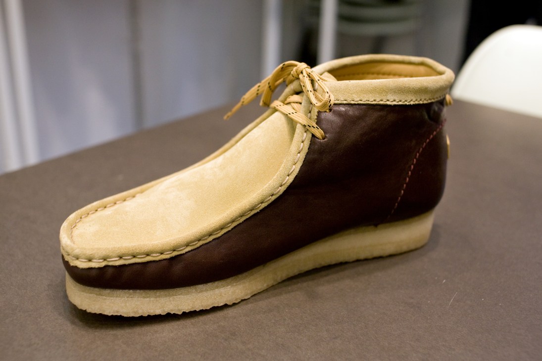 Rocky Mountain and Clarks collaboration boot in cream and brown suede with crepe sole on display.