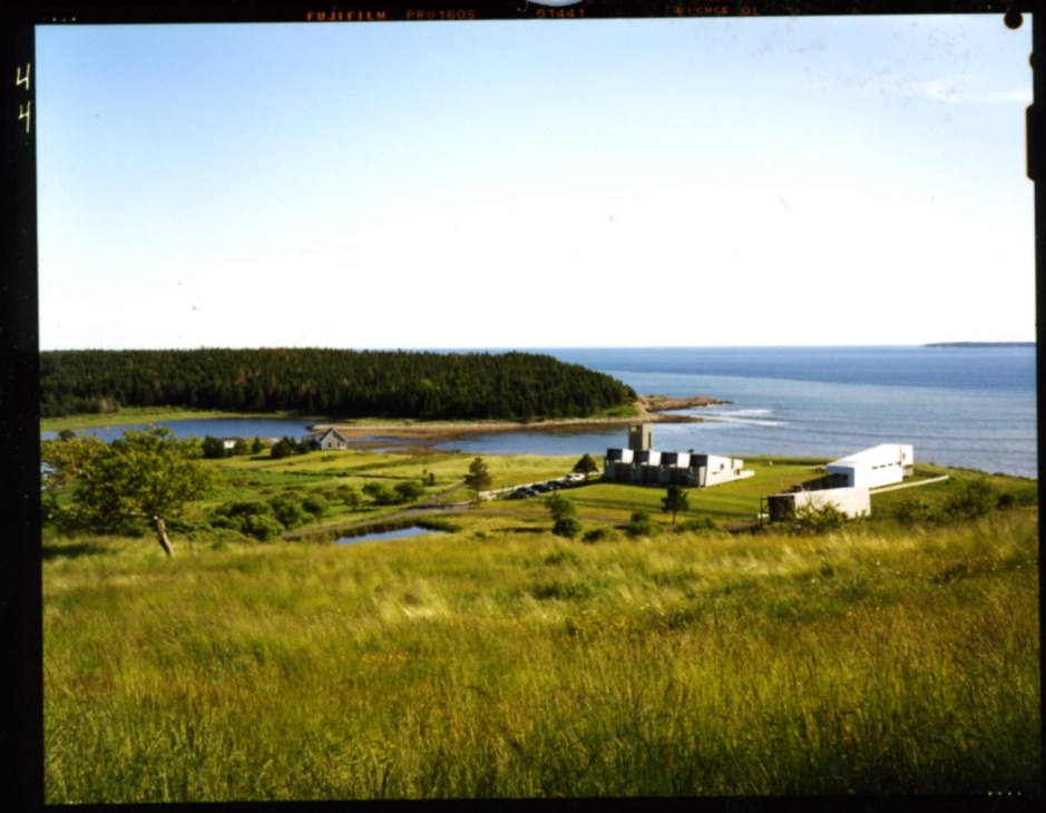 Aerial view of Ghost Laboratory campus with white modern buildings on a coastal Nova Scotia landscape overlooking the Atlantic Ocean.