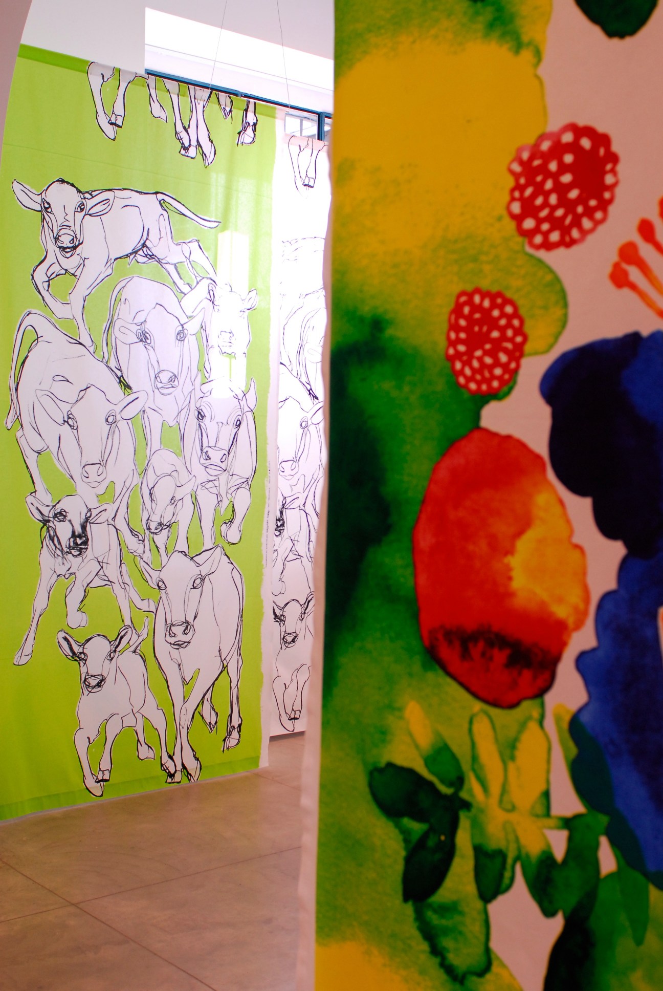 Colorful Marimekko fabric display featuring bold floral and animal illustrations in vibrant hues.
