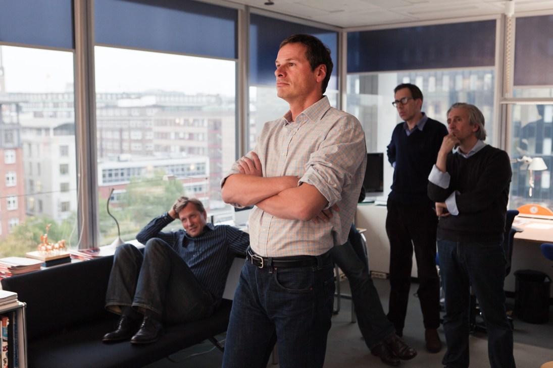 Der Spiegel staff members in a high-rise office reviewing magazine covers before publication.