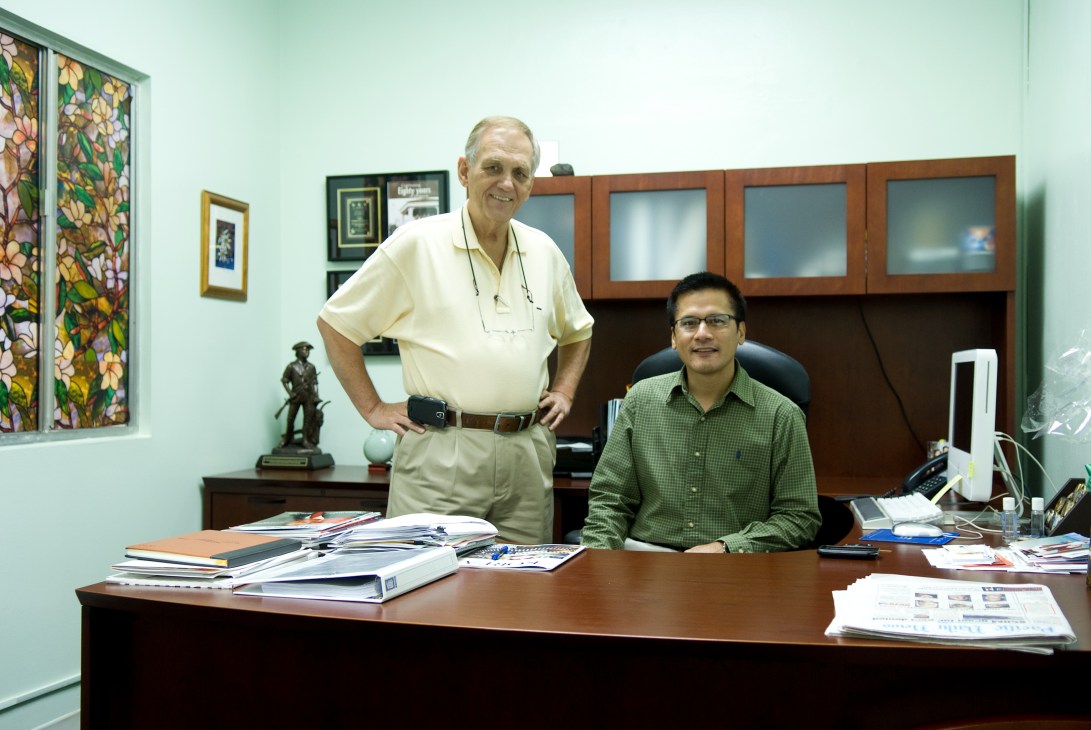 David Leddy, president of the Chamber of Commerce, standing with fellow member Carl Peterson in an office.