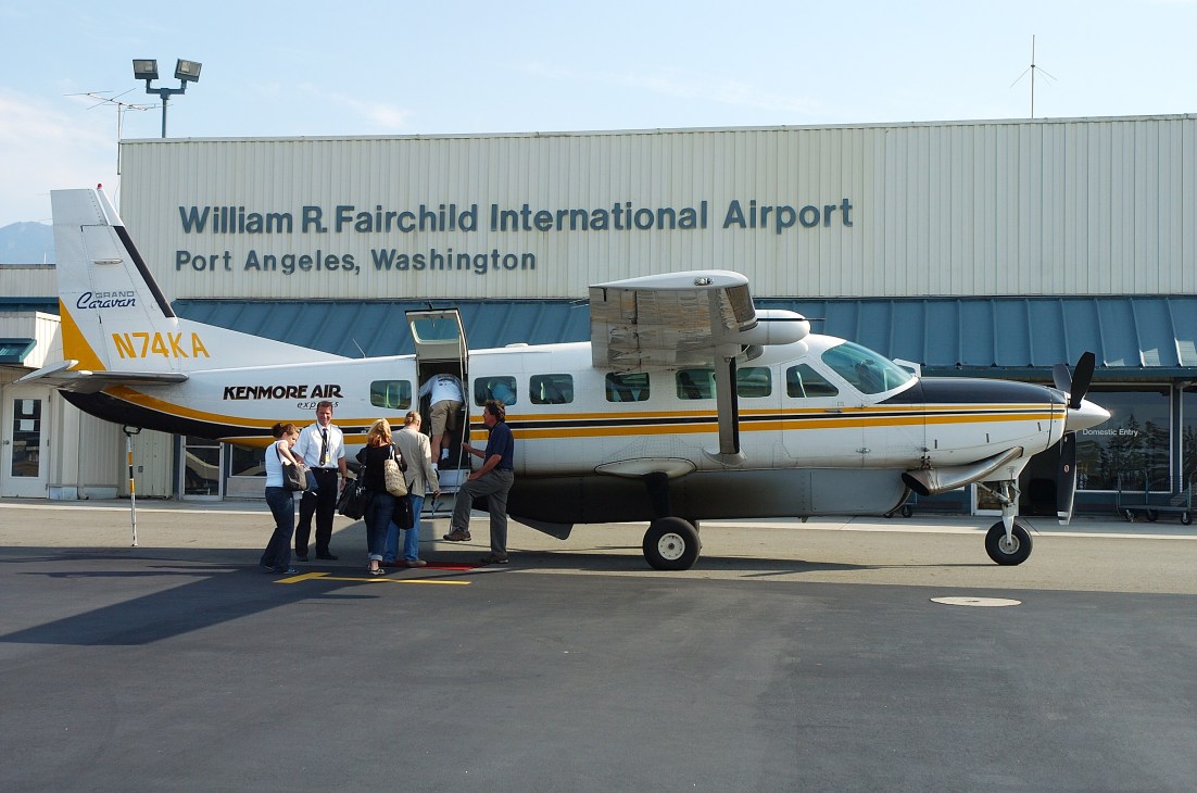 Kenmore Air passenger aircraft with yellow and blue livery at William R. Fairchild International Airport in Port Angeles, Washington.