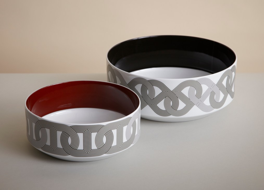 Two ceramic salad bowls with geometric patterns and colored interiors by Hermès.