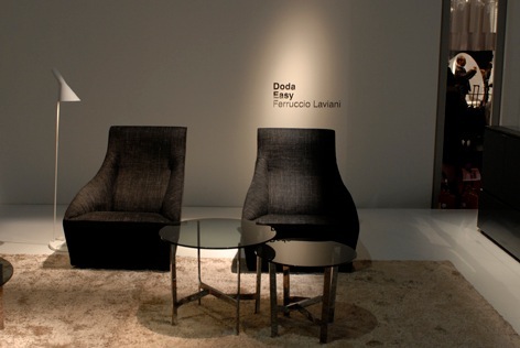 Two black upholstered 'Doda' armchairs by Ferruccio Laviani displayed at Molteni & C's showroom.