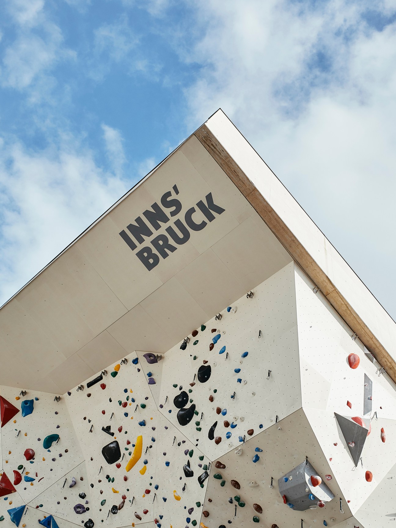 Outdoor climbing wall with colorful holds and overhang at Kletterzentrum-Innsbruck climbing center