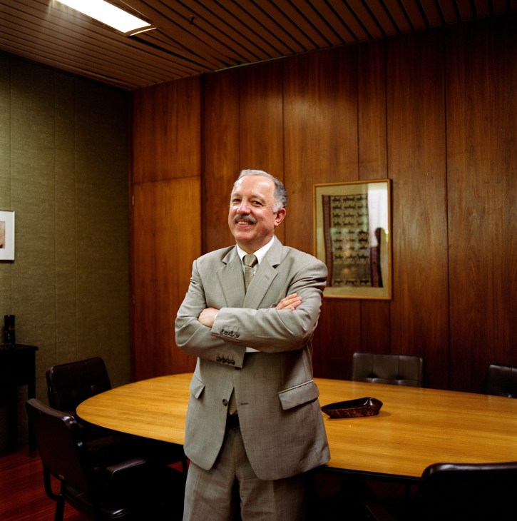 Gilberto Fonseca-Guimarães de Moura stands with crossed arms in a wood-paneled office at the Itamaraty Palace.