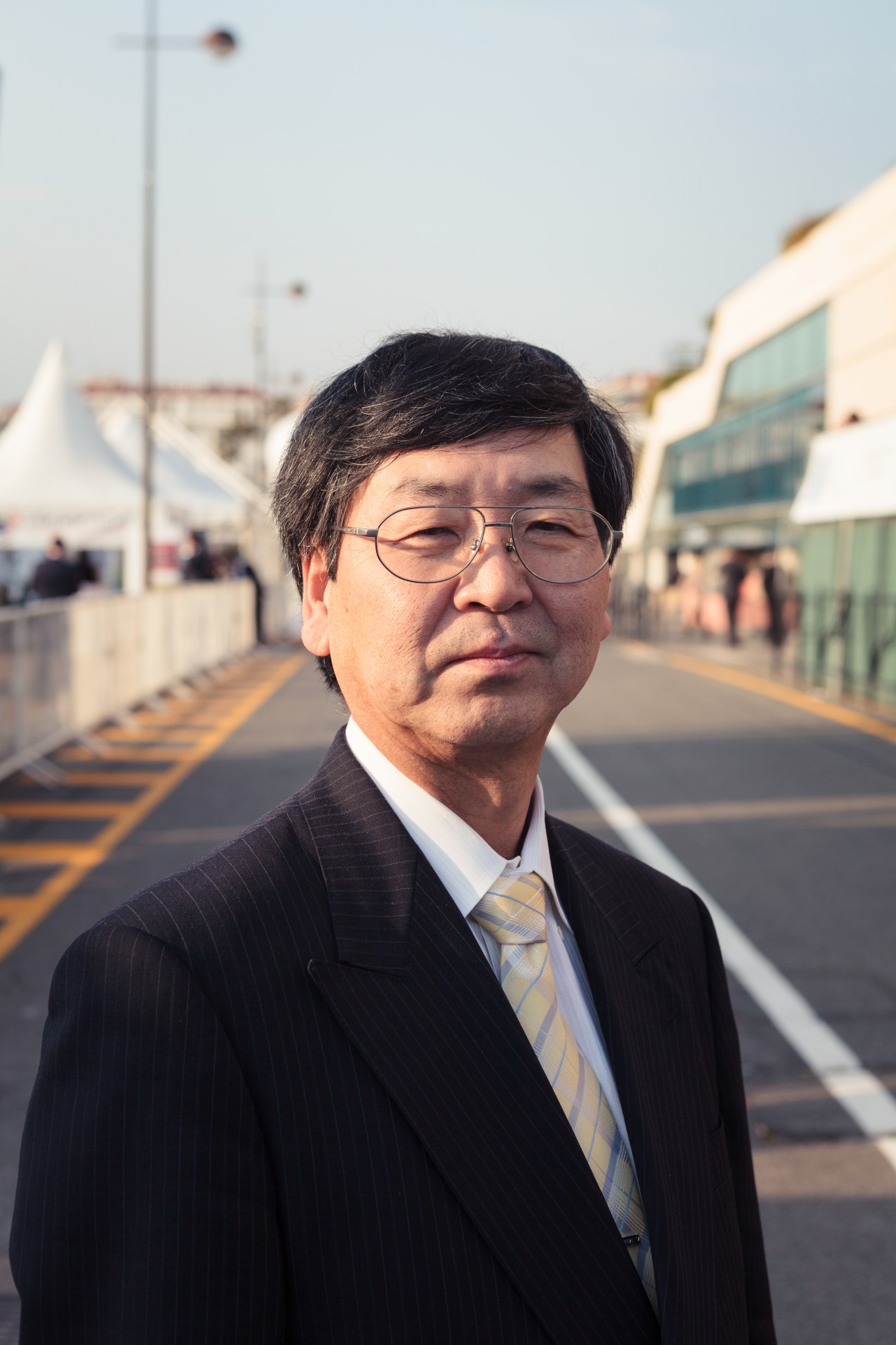 Shigeru Watanabe, senior director for policies at Tokyo metropolitan government, wearing glasses and dark suit at MIPIM.