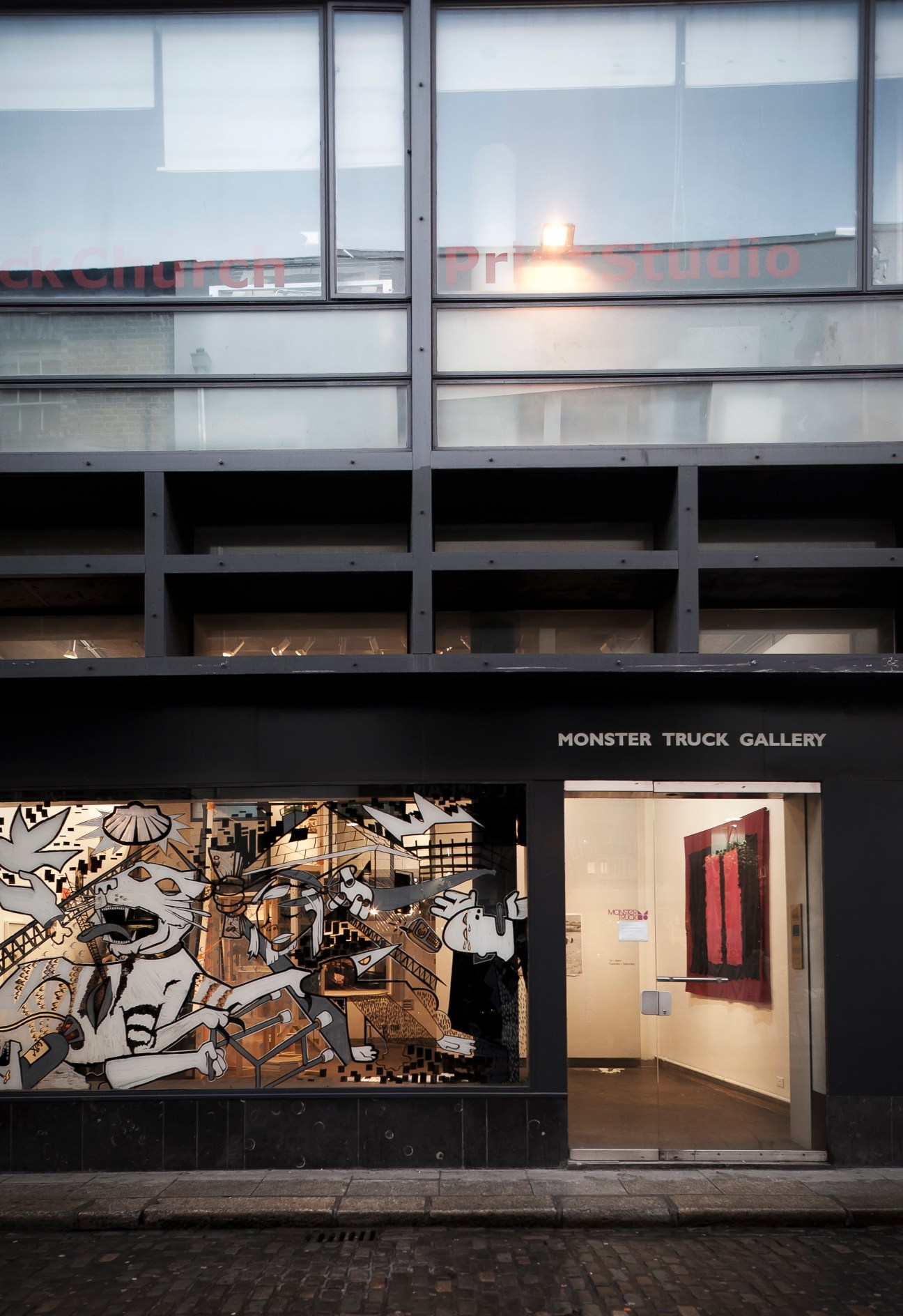 Monster Truck Gallery storefront in Dublin with black signage, large windows, and contemporary art displayed inside.