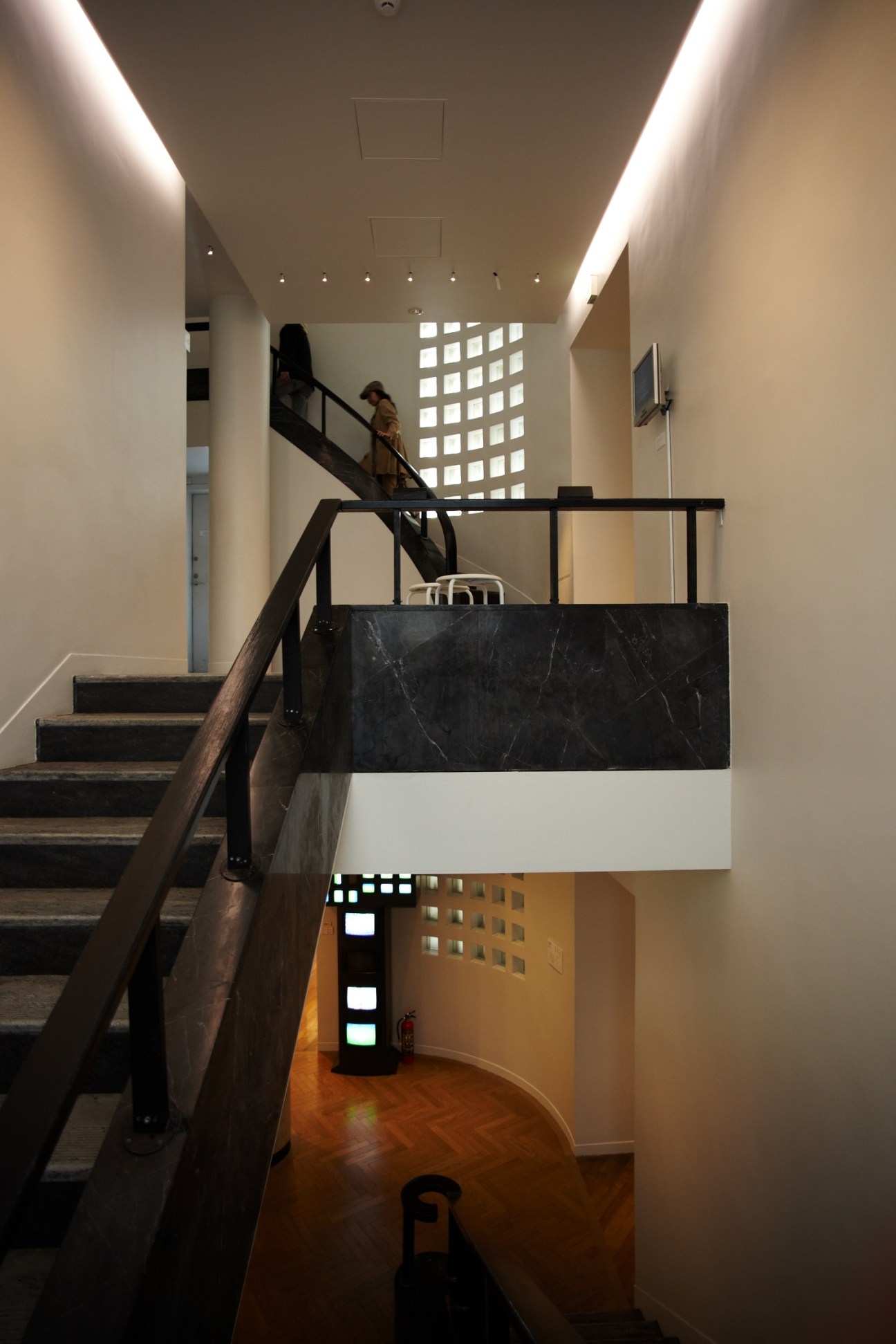 Interior staircase and connecting spaces of the Hara Museum of Contemporary Art in Tokyo with modern lighting and minimalist design.