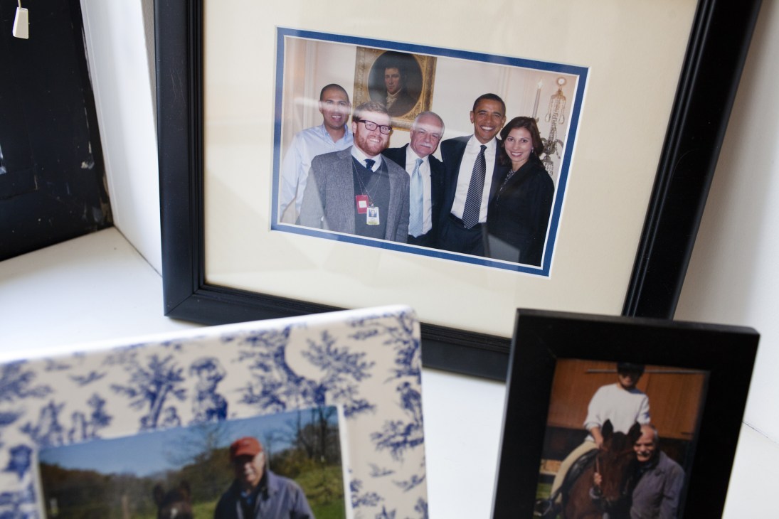 Framed photograph of five people including Barack Obama at what appears to be an official White House meeting.