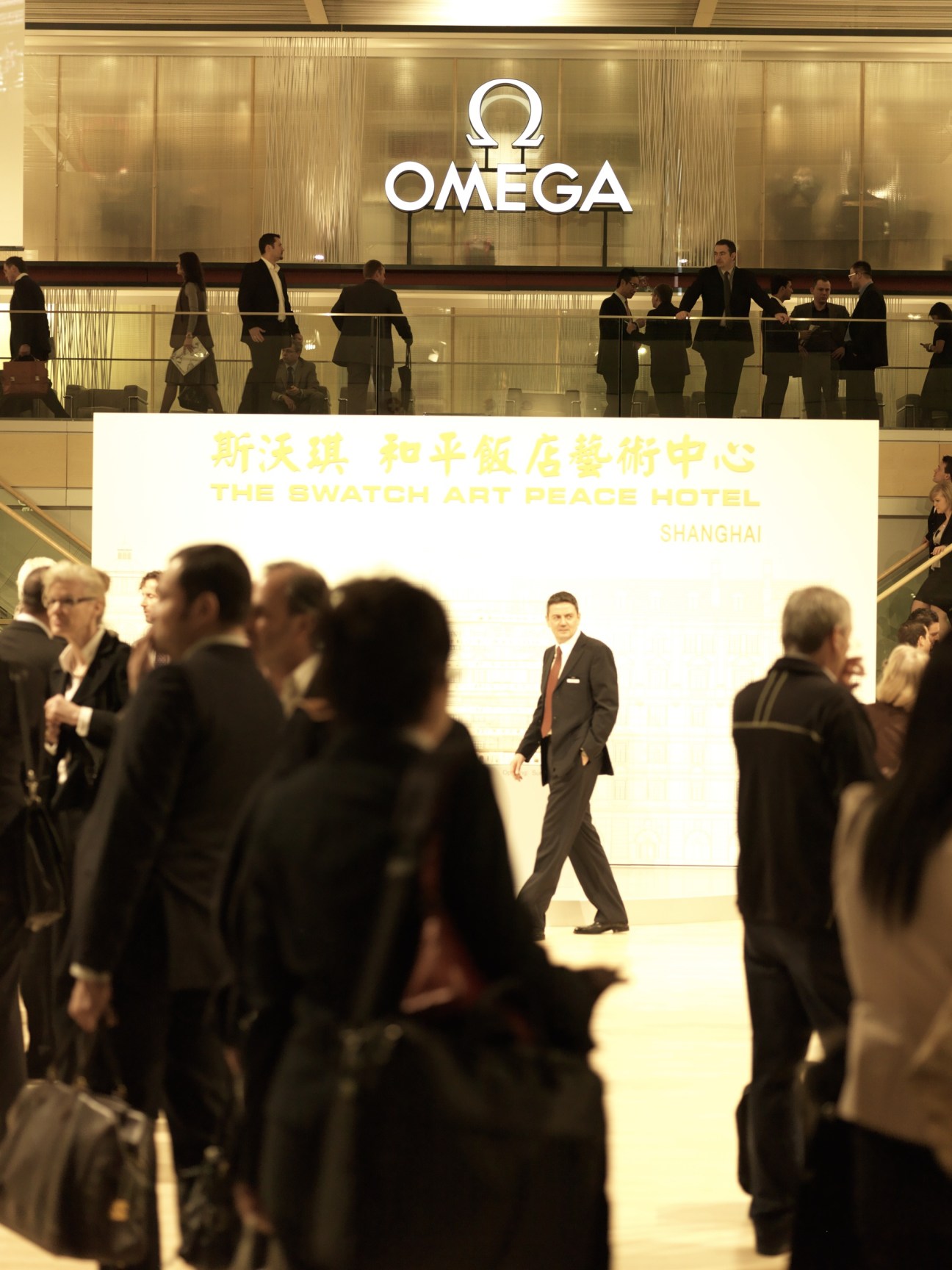 Visitors at the Omega stand at BaselWorld, with the Omega logo and signage visible above the crowd.