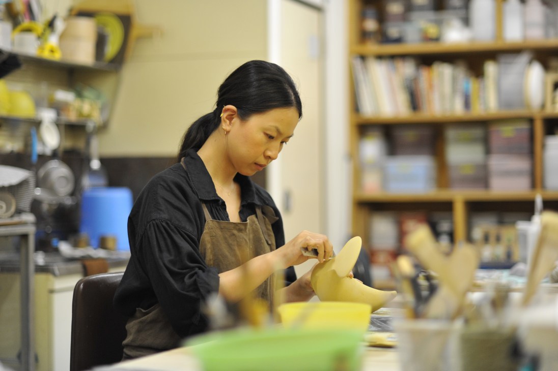 Potter Rie Ito working on a ceramic bird piece in her Osaka studio