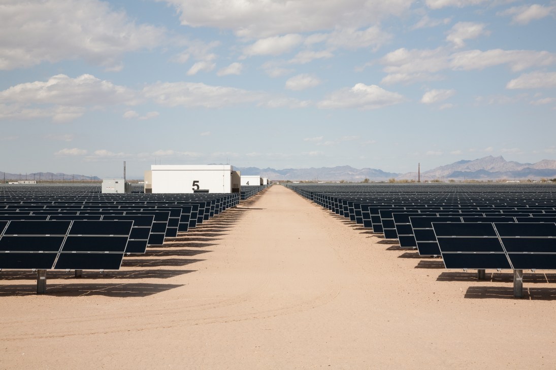 A 20MW photovoltaic plant owned by NRG in Blythe, California, with solar panels lining a desert road.