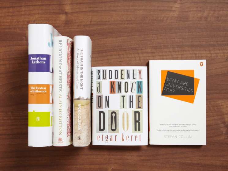 Five books arranged on a wooden surface: Jonathan Lethem's The Ecstasy of Influence, Religion for Atheists, The Train in the Night, Suddenly a Knock on the Door by Etgar Keret, and What are Universities for? by Stefan Collini.