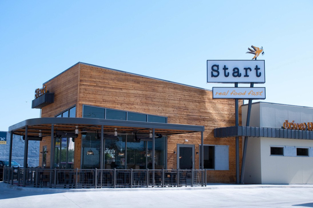Start Restaurant and Drive-through building in Dallas with wooden exterior and signage reading 'Start' and 'real food fast'.