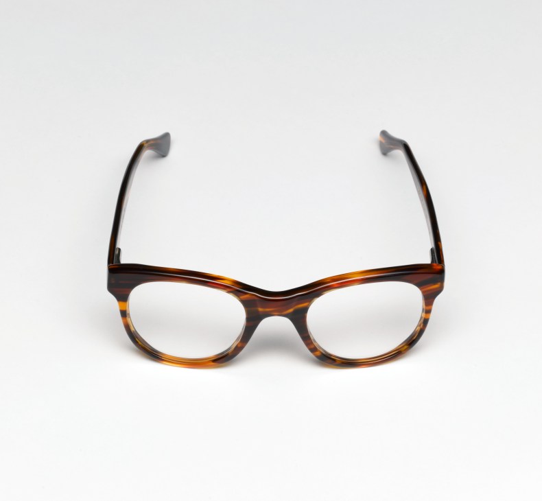 Tortoiseshell acetate eyeglasses with rounded frames on white background.