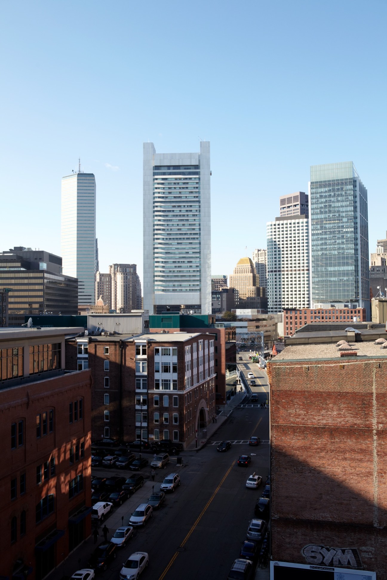 Fort Point Channel's red-brick warehouses with downtown Boston skyline in background.