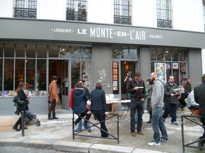 Le Monte-en-l'air bookshop and gallery storefront in Paris with customers browsing outside.