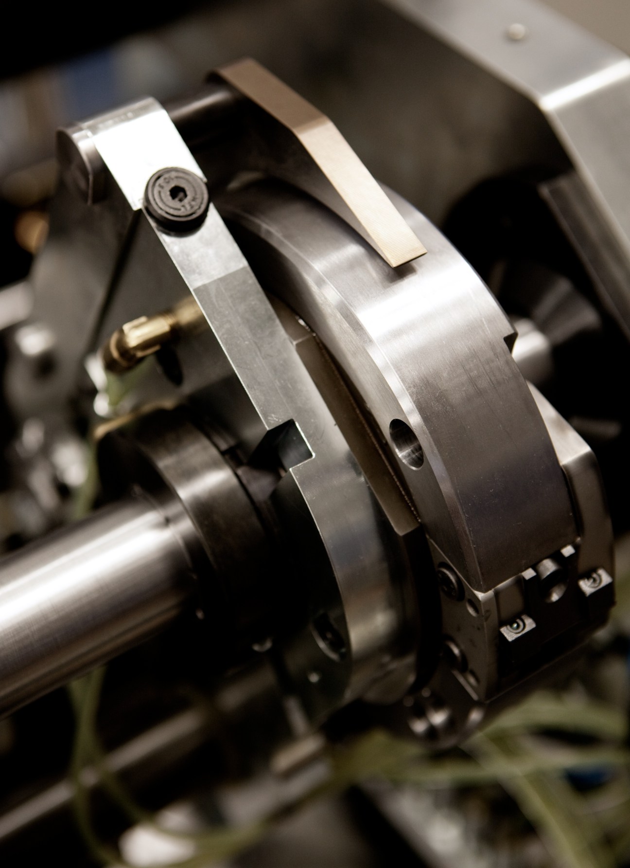 Close-up detail of a Tolerans stitching machine's metal stapling mechanism.