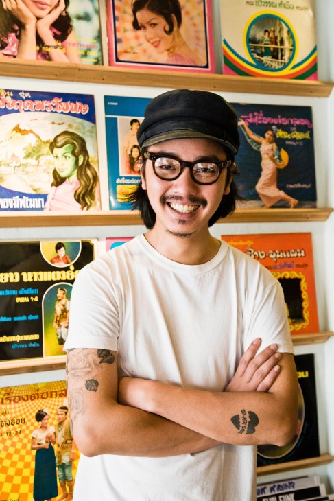 Nattapon Siangsukon poses in front of shelves of vintage Thai vinyl records at Zudrangma HQ Records.