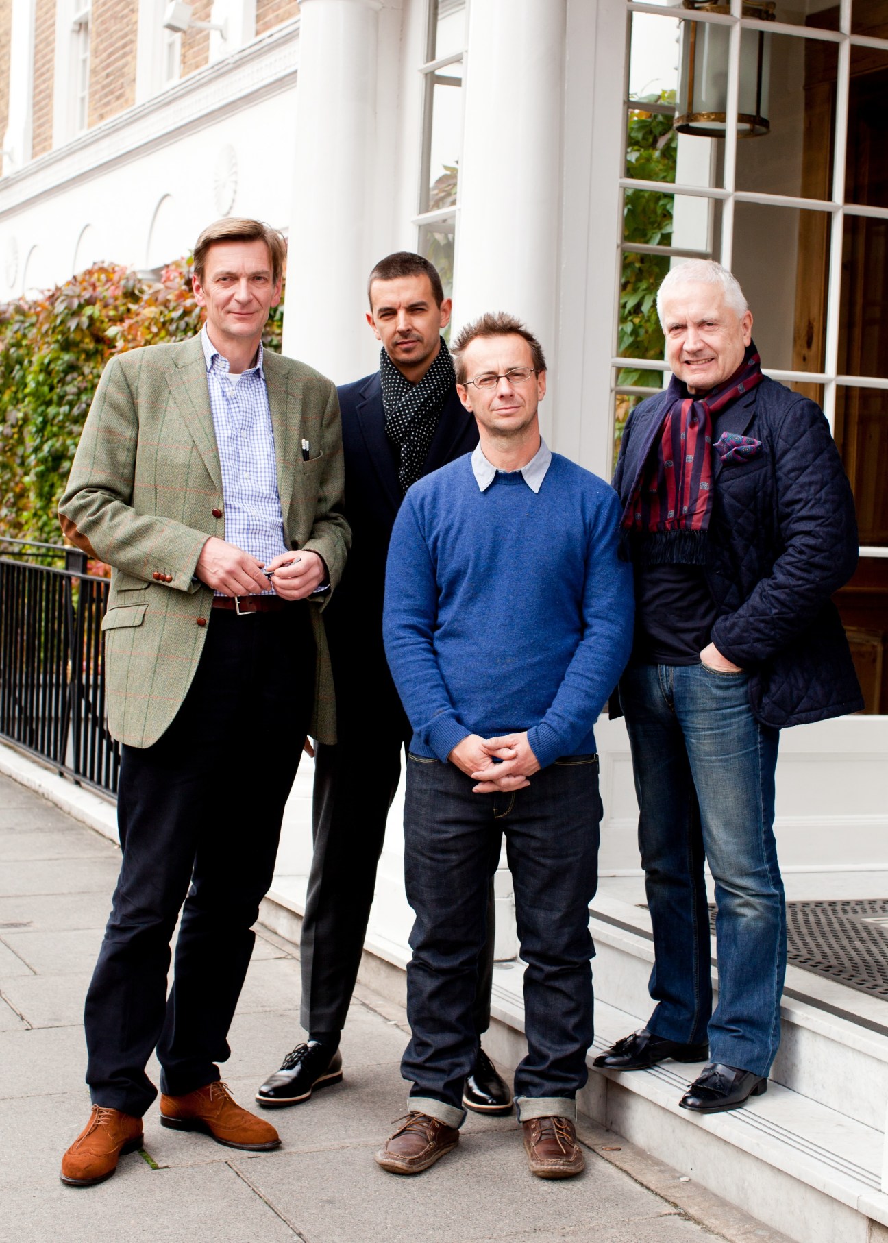 Four businessmen standing outside a white building: Till Reiter (Ludwig Reiter shoes), Gary Bott (Globe-Trotter), David Hieatt (Hiut Denim), and Alan Lewis (Crombie).