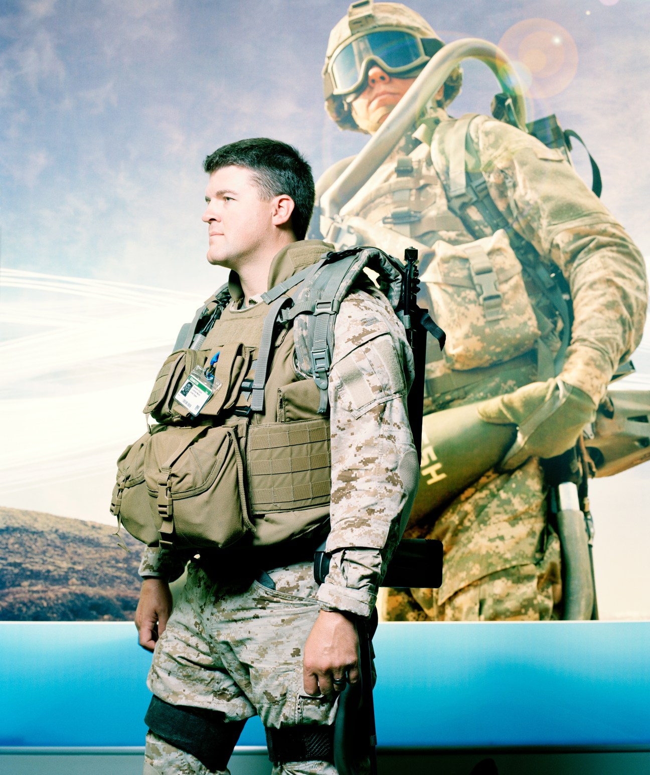 Soldier wearing Lockheed Martin's HULC exoskeleton and tactical gear against a blue sky background.