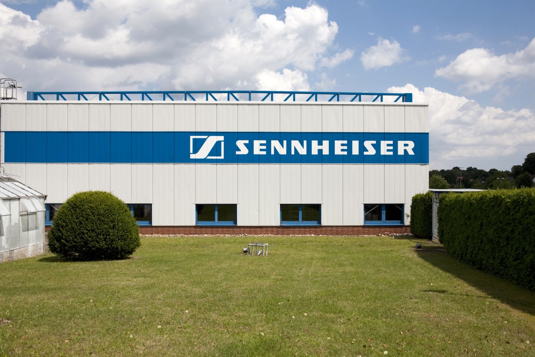 Sennheiser headquarters building with blue and white facade and logo in Wennebostel, Germany.