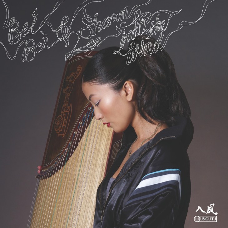 Bei Bei holds a traditional guzheng Chinese harp with neon text overlay reading "Bei Bei Shawn Lee Into The Wind".