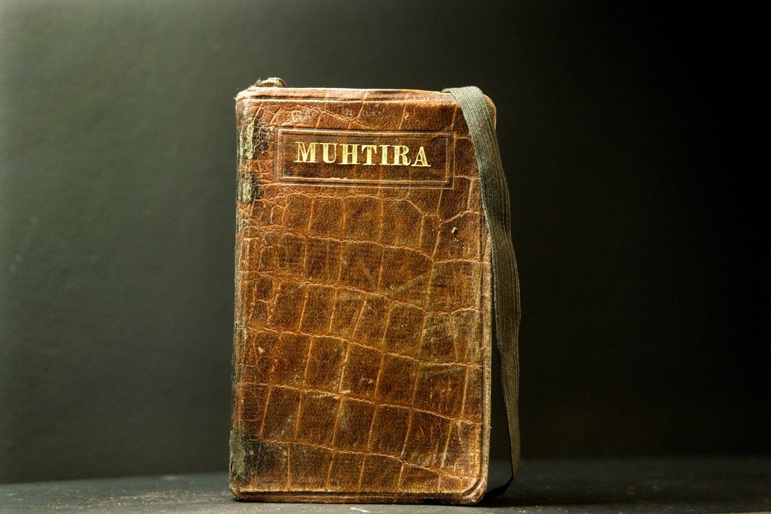 An aged leather-bound notebook labeled 'MUHTIRA' with crocodile embossing and gold lettering from the Ece archives.