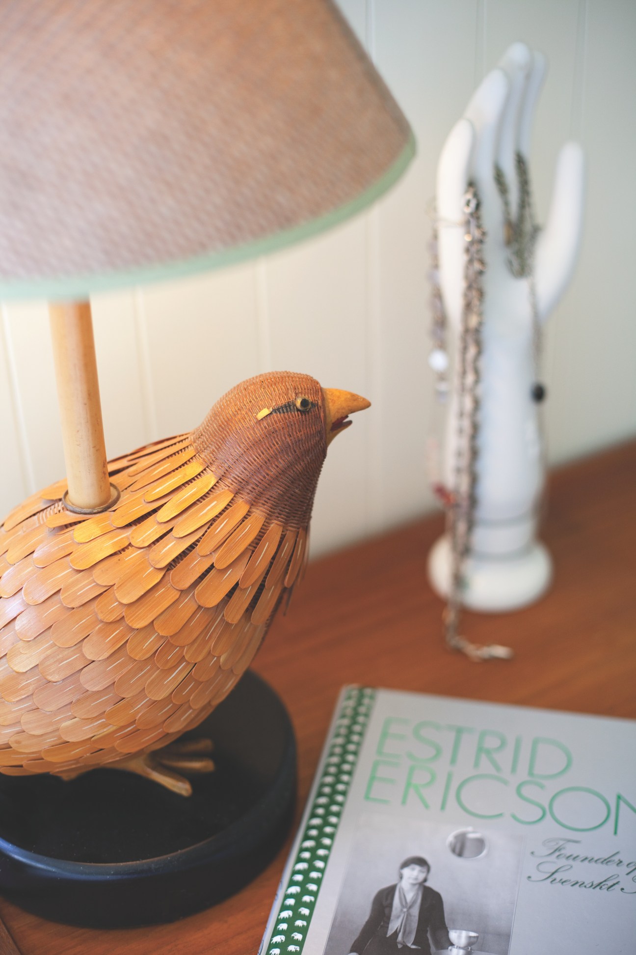 Wooden bird-shaped lamp base with woven feather details and a cylindrical stem.