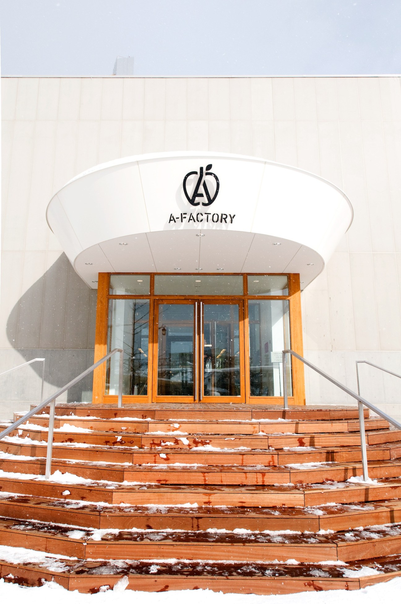 Exterior of A-Factory building in Aomori with wooden stairs leading to entrance