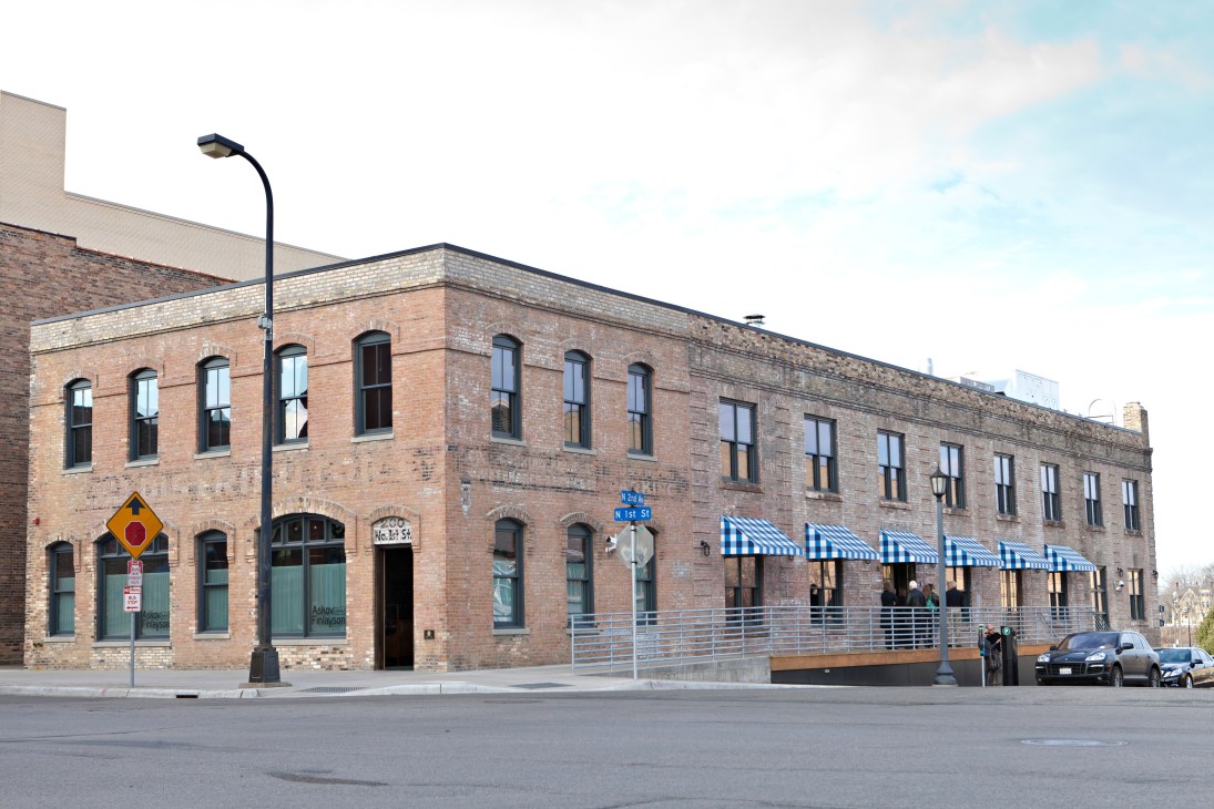 A red brick industrial building housing The Bachelor Farmer restaurant, Marvel bar and Askov Finlayson shop in Minneapolis's North Loop.