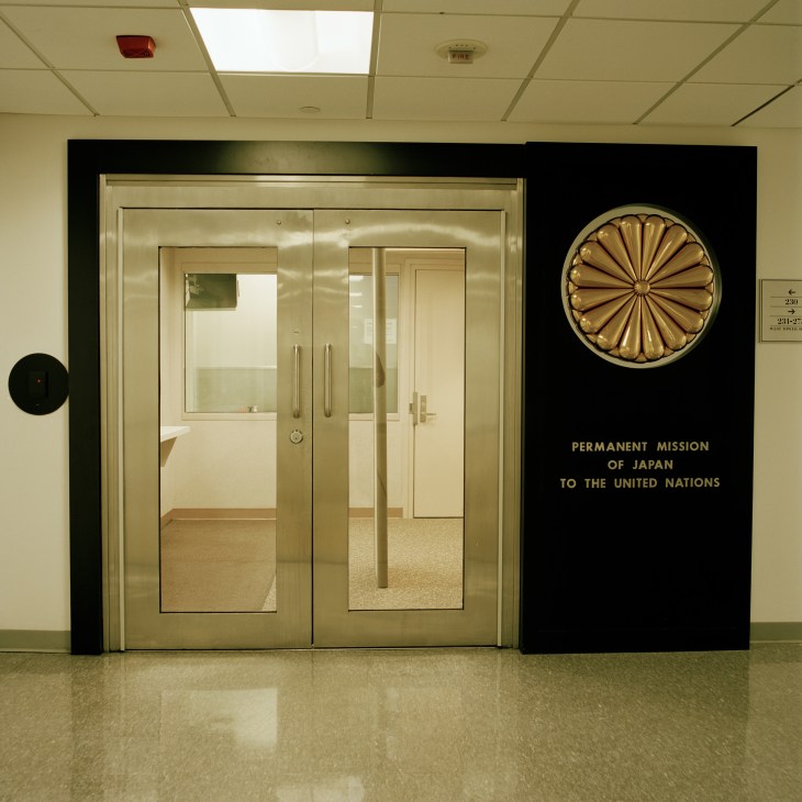 Entrance to the Permanent Mission of Japan to the United Nations featuring glass doors and decorative circular medallion.
