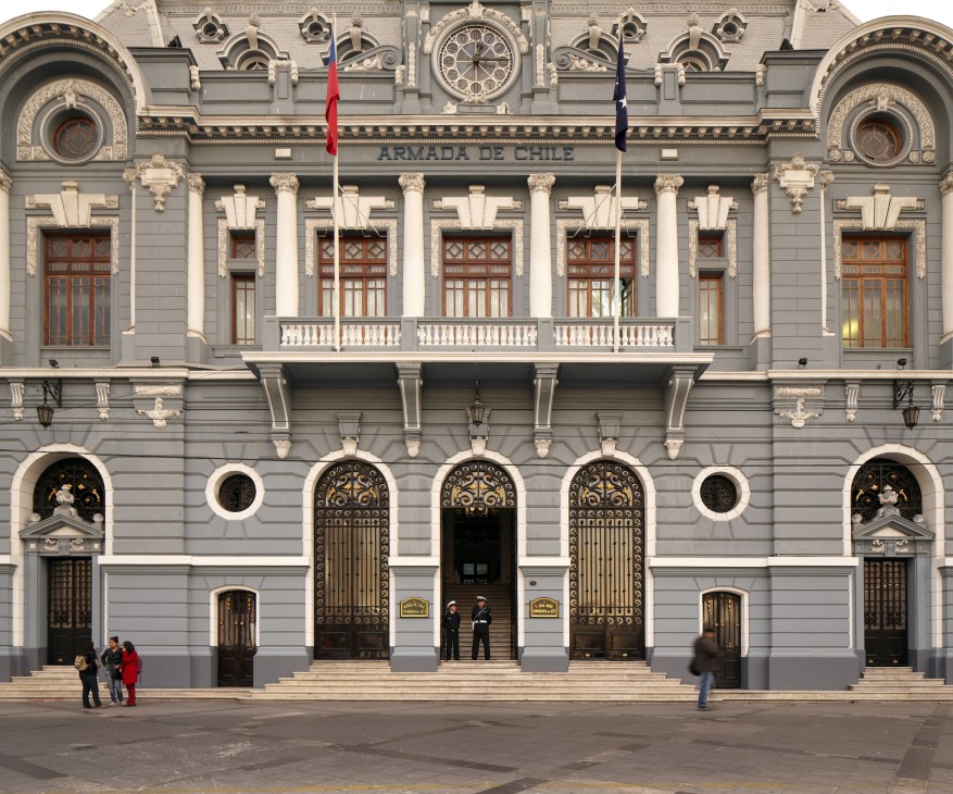 Neoclassical facade of the Chilean Navy headquarters building with ornate columns and arches at Plaza Sotomayor.