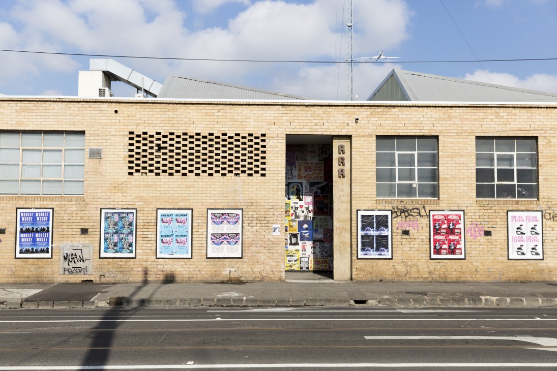 Brick facade of Triple R radio station in Brunswick with geometric pattern window and event posters.
