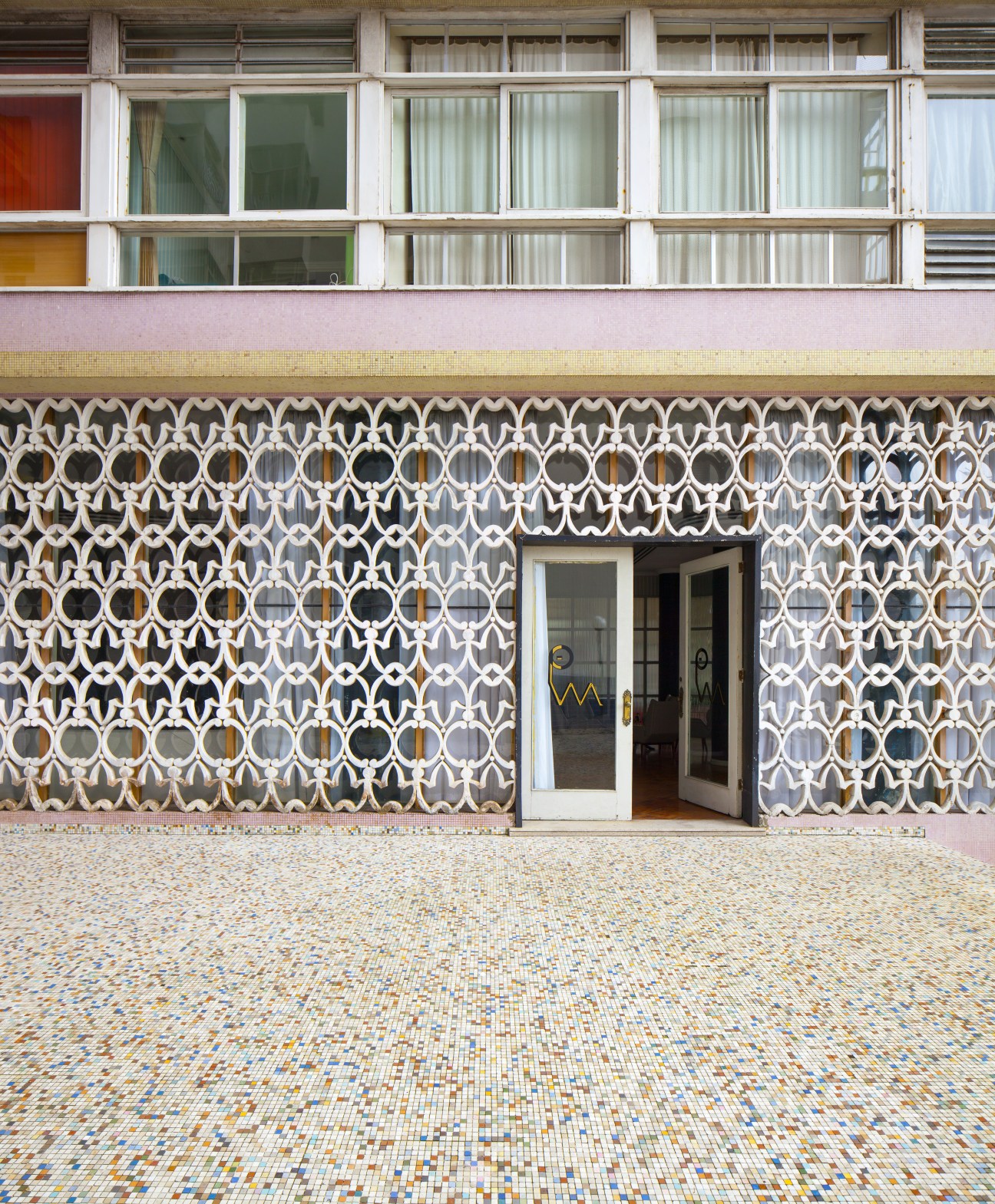 Parque Verde Mar building entrance with colorful patterned tile facade and glass doors.