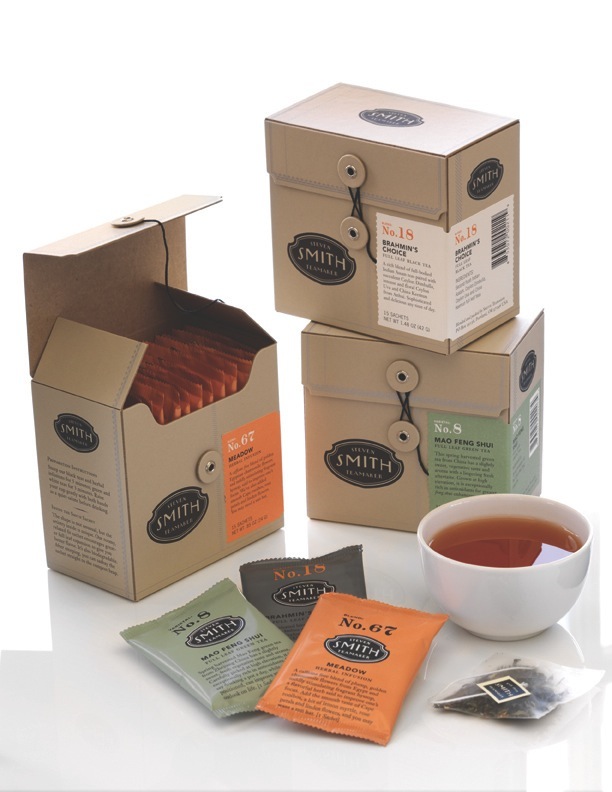 Steven Smith Teamaker tea boxes, packets, and a brewed cup of tea on white background.